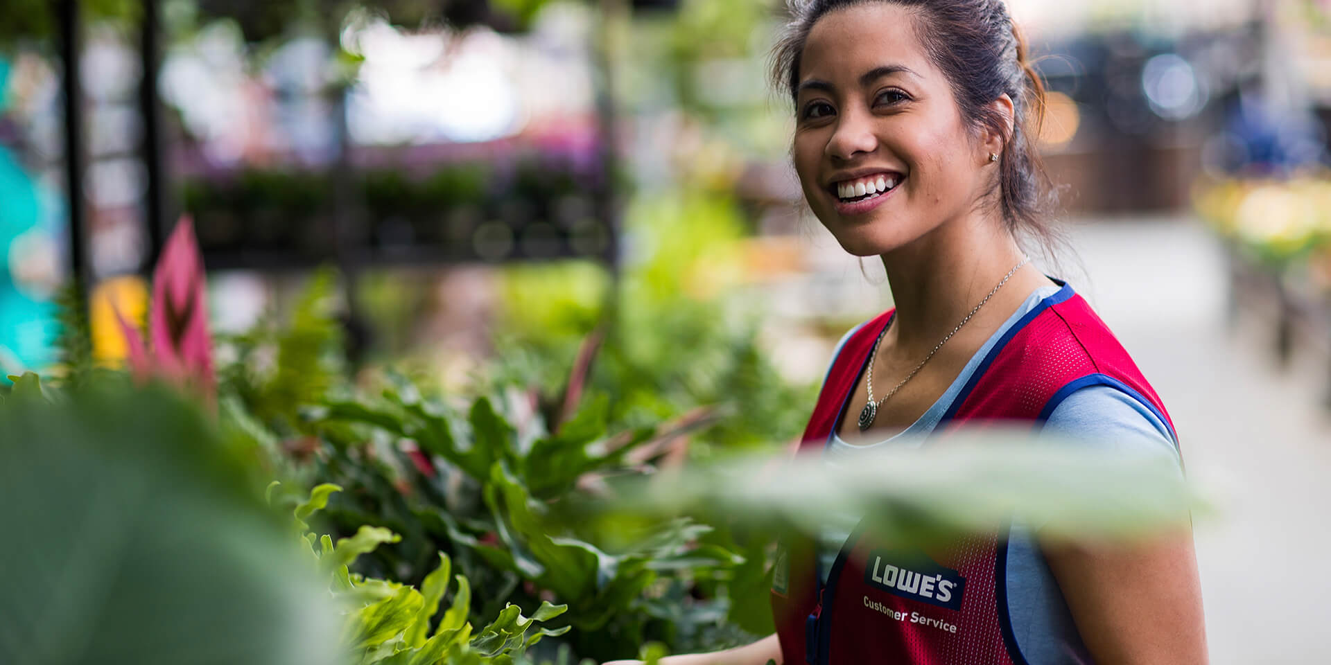 Female Lowes associate in plant department 